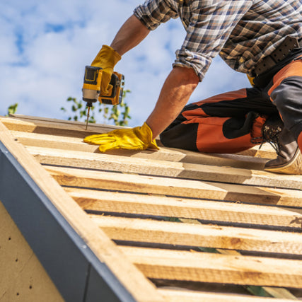 DIY RentalsA yellow power drill being used to install roof framing.