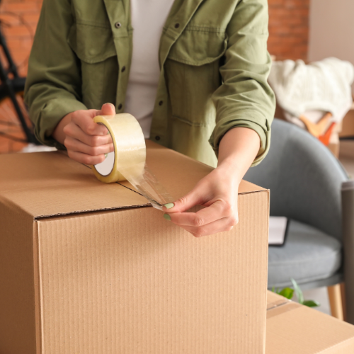 A cardboard box being taped.